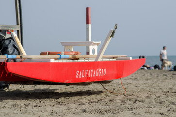 Lifeguard boat on the beach for emergencies, high visibility red colour. Sea beaches, coastal...