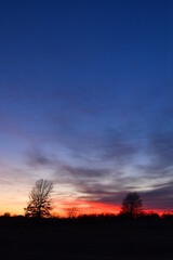 Fototapeta premium Dramatic Sunset Over a Rural Field