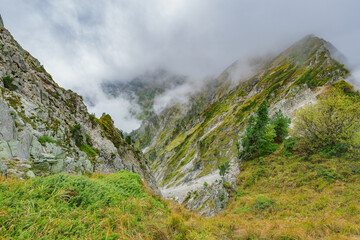 Clouds cover mountain tops at autumn day. Caucasus.