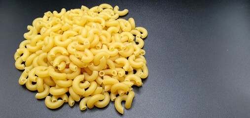 Raw pasta isolated. Raw pasta on a black background. Pasta background. Cooking pasta in the kitchen.