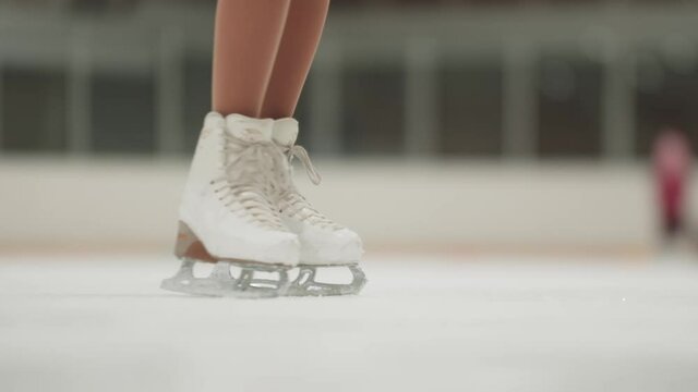 Little girl figure skater stops on the rink