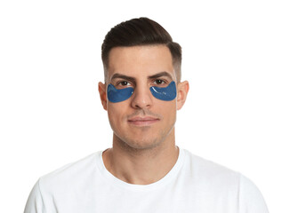 Man with blue under eye patches on white background