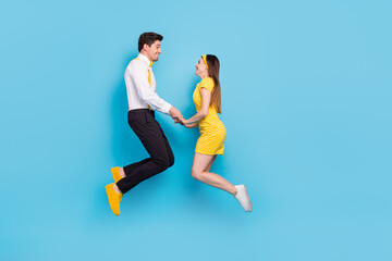 Fototapeta na wymiar Full size profile portrait of excited attractive lady handsome guy hold arms isolated on blue color background