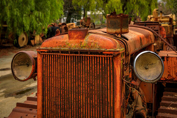 Close up of the front grille of an old heavy equipment tractor, a rural setting