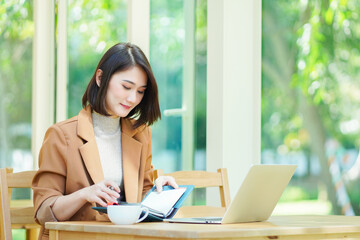 Fototapeta premium woman working on laptop in cafe