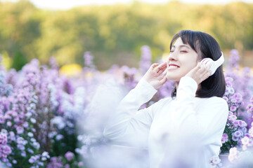 woman listening to music in the flower garden