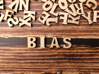 Top view wooden word with text BIAS on a wooden background. - obrazy, fototapety, plakaty