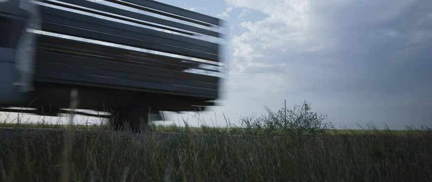 cars are driving on the road . drives past the camera