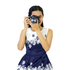 Young traveler in blue dress looks through the viewfinder while shooting with the camera.