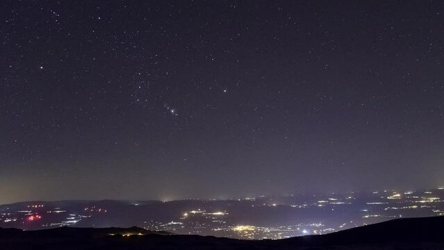 Movement of the stars with Orion over portuguese cities from highest mountain Torre, Serra da Estrela, Portugal