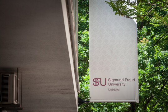 LJUBLJANA, SLOVENIA - JUNE 14, 2021: Logo of SFU Sigmund Freud University Ljubljana on their campus. Sigmund Freud University is a private education structure specialized in Psychotherapy studies...