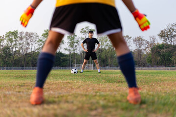 Sports and recreation concept a male amateur player practicing as a goalkeeper position rehearsing to catch the ball from free-kicks