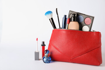 Cosmetic bag and makeup products with accessories on white background