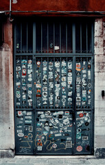 Metal door full of stickers in Italy