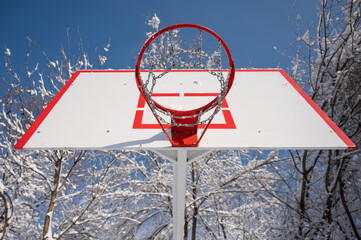 Basketball hoop in the snow in winter. 