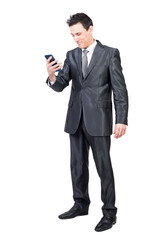 Content man in suit browsing smartphone. White background.