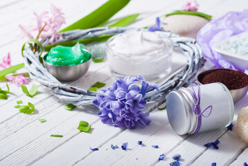 cosmetic cream product samples with hyacinth flowers on white wooden background