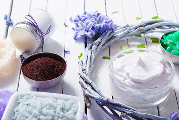 cosmetic cream product samples with hyacinth flowers on white wooden background