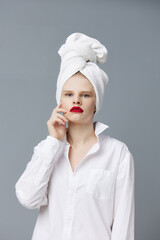 portrait of a woman white shirt cosmetics with towel on head Lifestyle posing