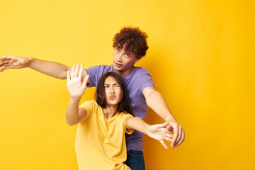 teenagers in colorful t-shirts posing friendship fun yellow background unaltered