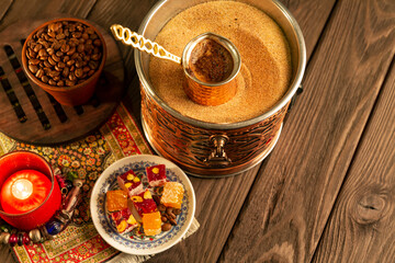 Traditional Turkish coffee with foam in cezve prepared on hot sand in authentic Turkish Copper.