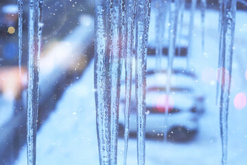 icicles on the roof urban background view winter city