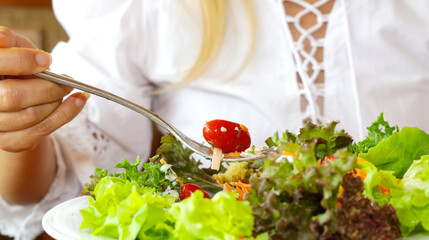 Selective focus of woman hand eating healthy food of salad-healthy lifestyle diet concept