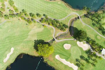 Aerial view of the green golf course in Thailand Beautiful green grass and trees on a golf field with fairway and putting green in summer season