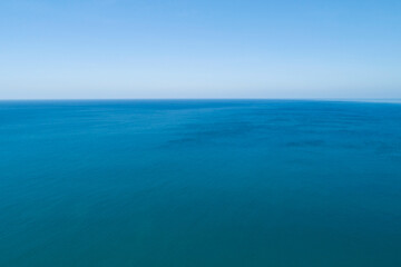 Aerial view of a blue sea surface water texture background and sun reflections Aerial flying drone view Waves water surface texture on sunny tropical ocean in Phuket island Thailand