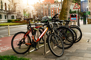 Naklejka na ściany i meble Bicycle at bike station for rent to travel or transport in the city. Sustainable travel. Bicycle sharing system. Bicycle for city tour at bike parking station. Eco-friendly transport. Urban transport.