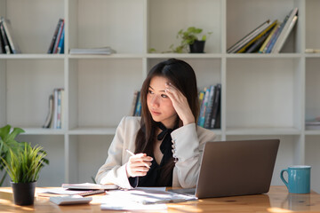 Portrait Young Asian businesswoman thinking for work at her office.