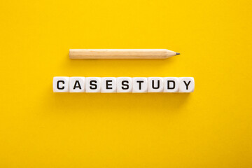 Case Study word with pencil on yellow background - Powered by Adobe