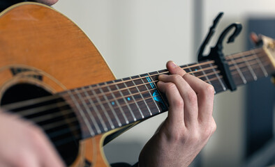 Fototapeta premium Close-up, male hands are playing the guitar.