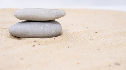 Fototapeta na wymiar zen stones on sand surface with copy space