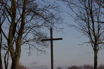 Cross on the top of the hill in winter