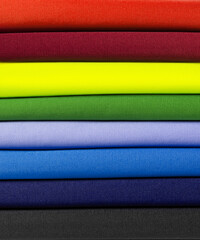 Folded stack of cotton fabric. rainbow colored textile background