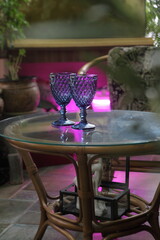 Two blue glasses on a glass table