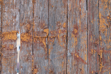 old boards from fences and gates are covered with dirt and old paint