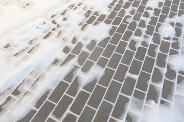 Paving slabs in the snow in winter.