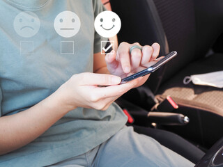 Young woman rating satisfaction with white icon, choose smiley face icon, very satisfied.