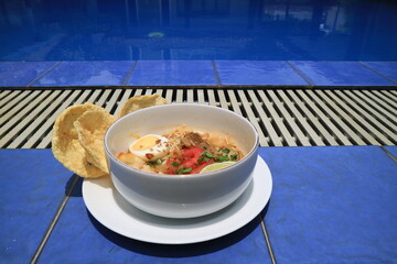 A bowl of Soto or Soup. Soto is a traditional soup consisting mainly of broth, meat and vegetables.