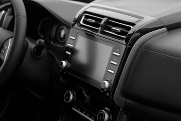 The interior of the car. Car-mounted tablet with mockup. Black and white photo