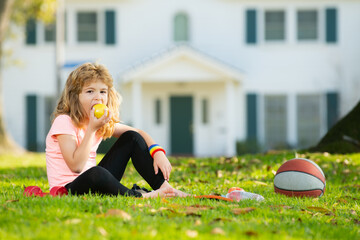 Kids relax on sport mat after sport exercises outdoor in park. Concept of children sport.