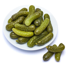 Plate of Tasty canned Whole green cornichons isolated on a white background