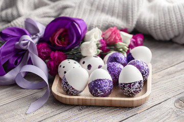 Close-up of Easter eggs decorated with purple sparkles.