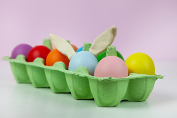 Happy Easter. Easter eggs. Chicken multicolored eggs on pink background.