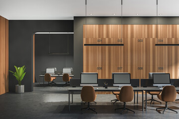 Dark office room interior with desktops, desks, armchairs, plant, arch