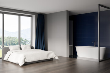Modern hotel room interior with king size bed, ceramic white bathtub. Blue tile on walls, Hardwood flooring. Panoramic window. 3d rendering.