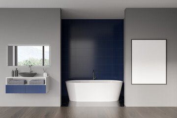 Fototapeta na wymiar Modern bathroom interior with white ceramic bathtub, sink. Blue tile on walls, hardwood flooring. Blank framed poster on grey wall. Mockup. 3d rendering.