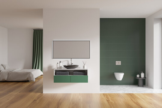 Modern hotel room interior with king size bed, sink and mirror, toilet. Green tile on walls, hardwood flooring. 3d rendering.